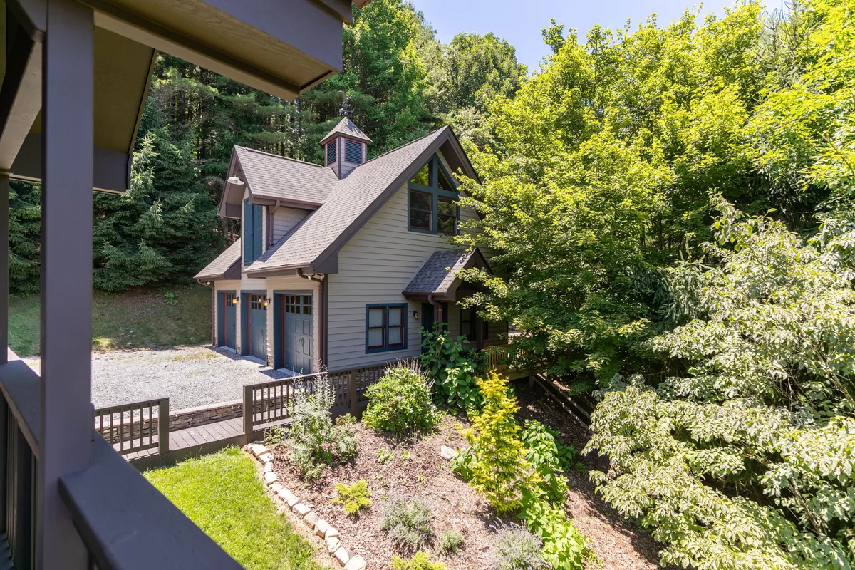 The front facade of the house is featured, surrounded by well-maintained greenery and a welcoming pathway. This scene suggests a safe, generous outdoor area perfect for children and pets to play, and for families to gather for group activities or celebrations.